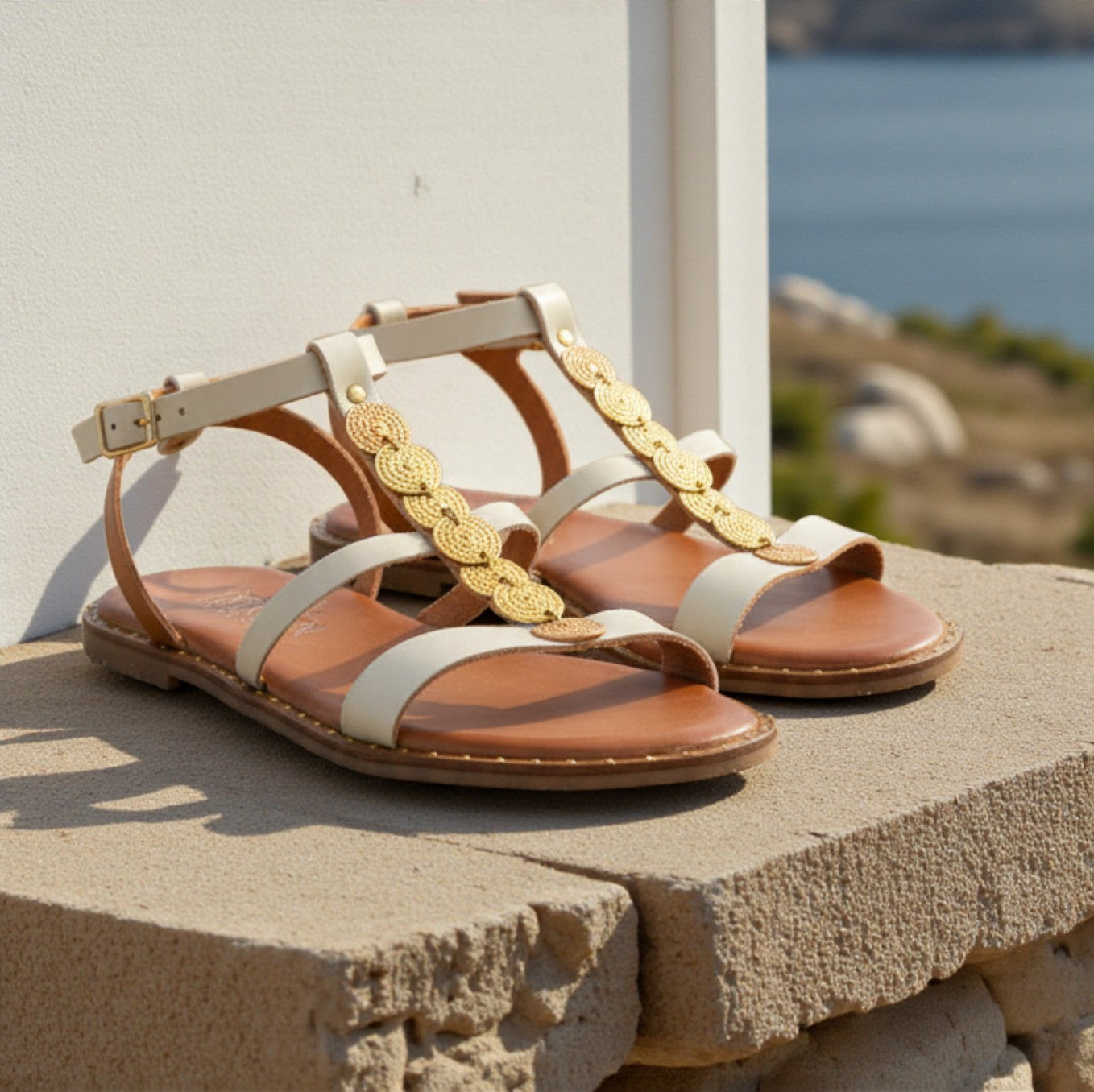 Elena off-white leather Greek sandal with gold discs