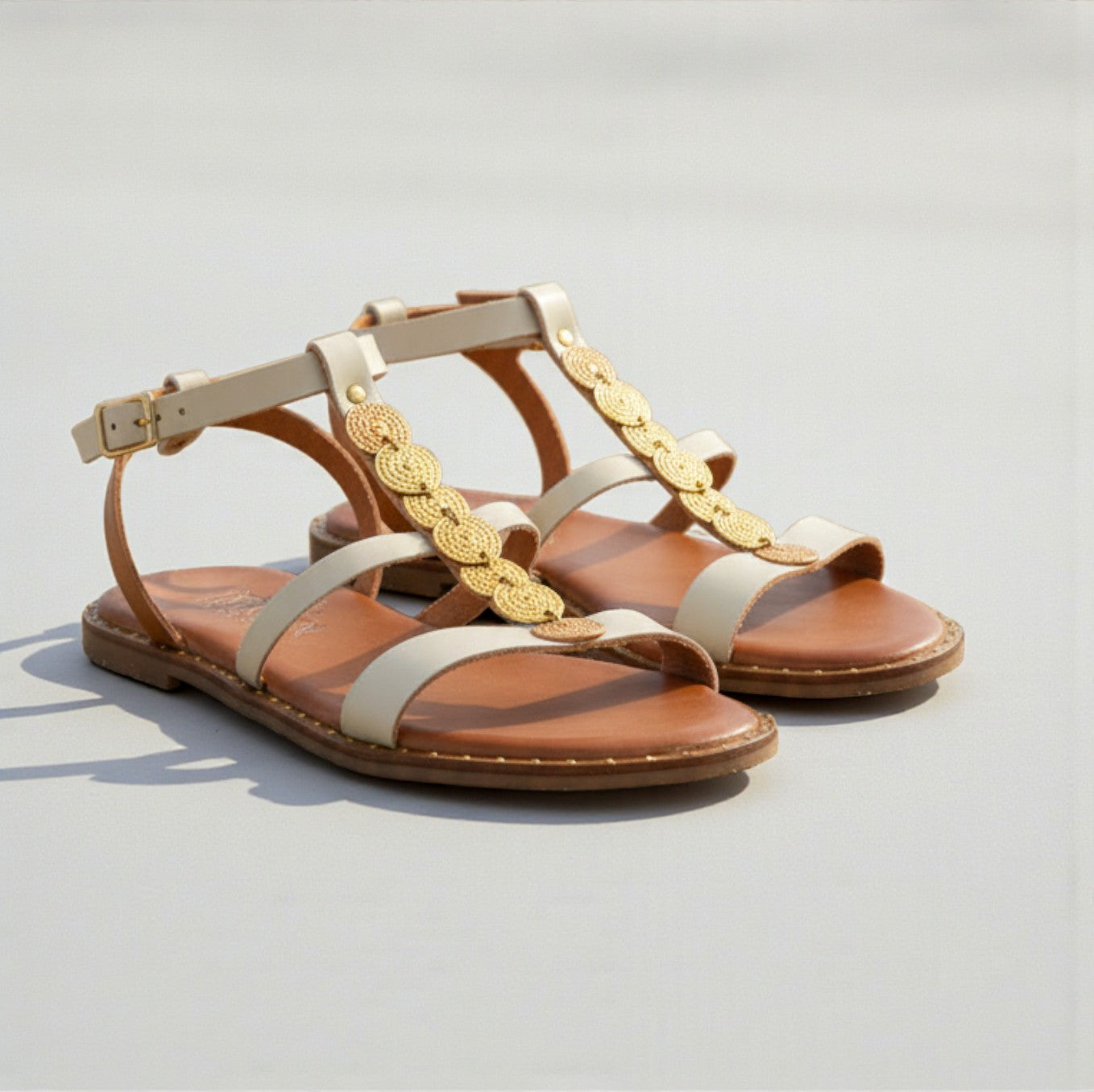 Elena off-white leather Greek sandal with gold discs