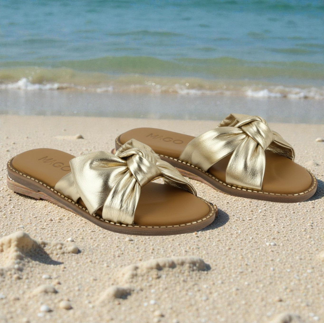 Yasmin gold leather flat sandal with knot detail