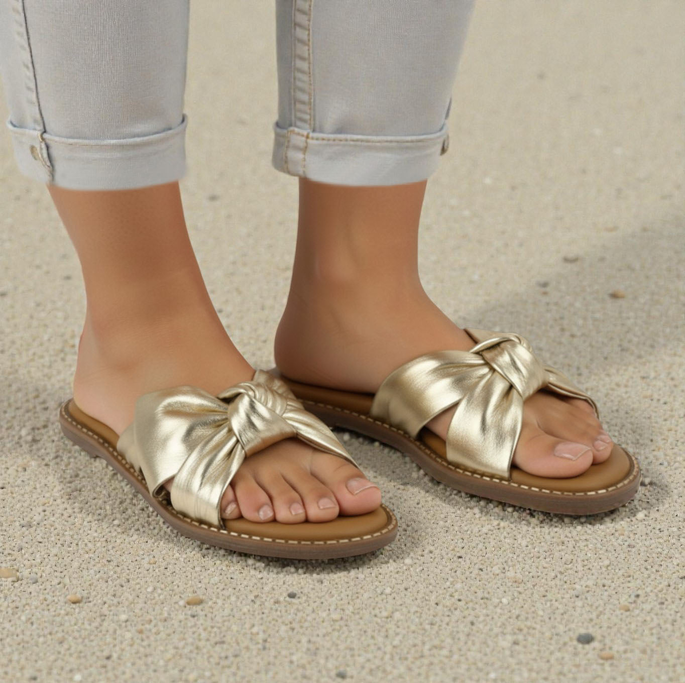 Yasmin gold leather flat sandal with knot detail