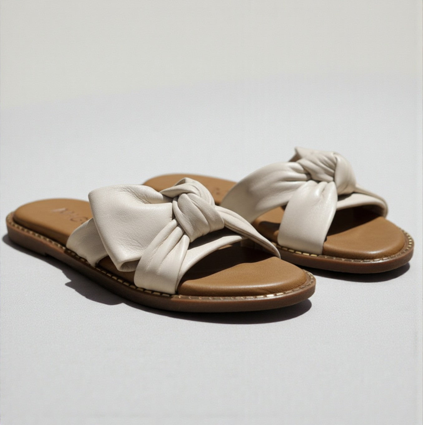 Yasmin off-white leather flat sandal with knot detail